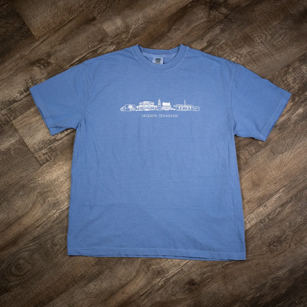 Blue Comfort Colors T-shirt printed with a Jackson, Tennessee skyline design