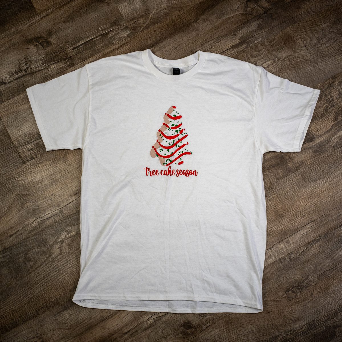 White T-shirt printed with a tree cake season design